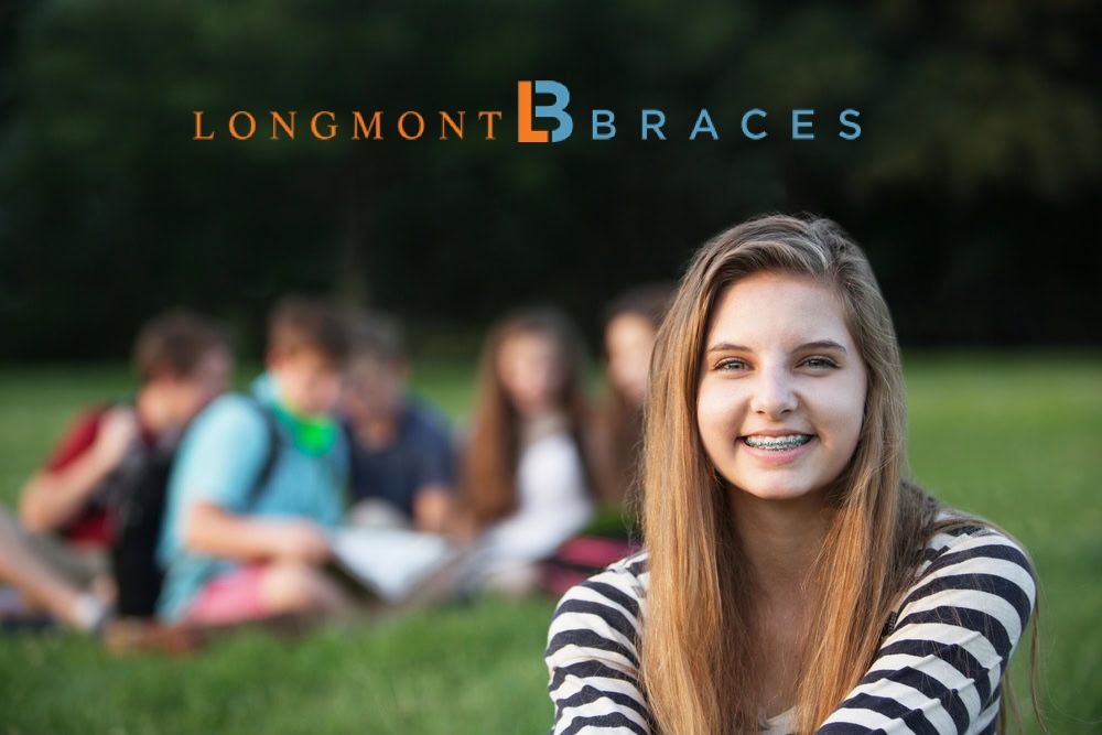 Teen girl smiling with braces outdoors at Longmont Braces